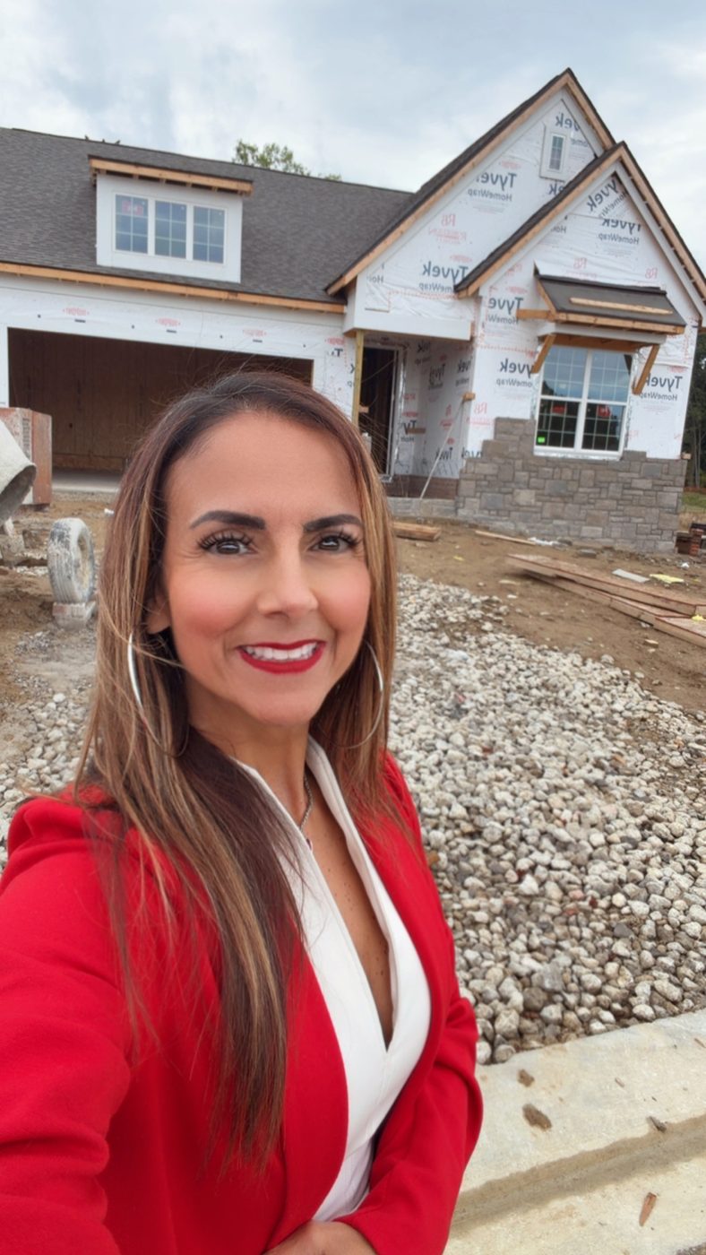 Derica Wade of Hearts to Homes standing at a new-construction home under construction in the South Lyon area.
