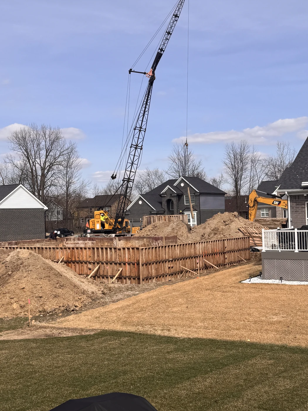 Wooden foundation forms set in an excavated hole to shape basement walls before concrete is poured