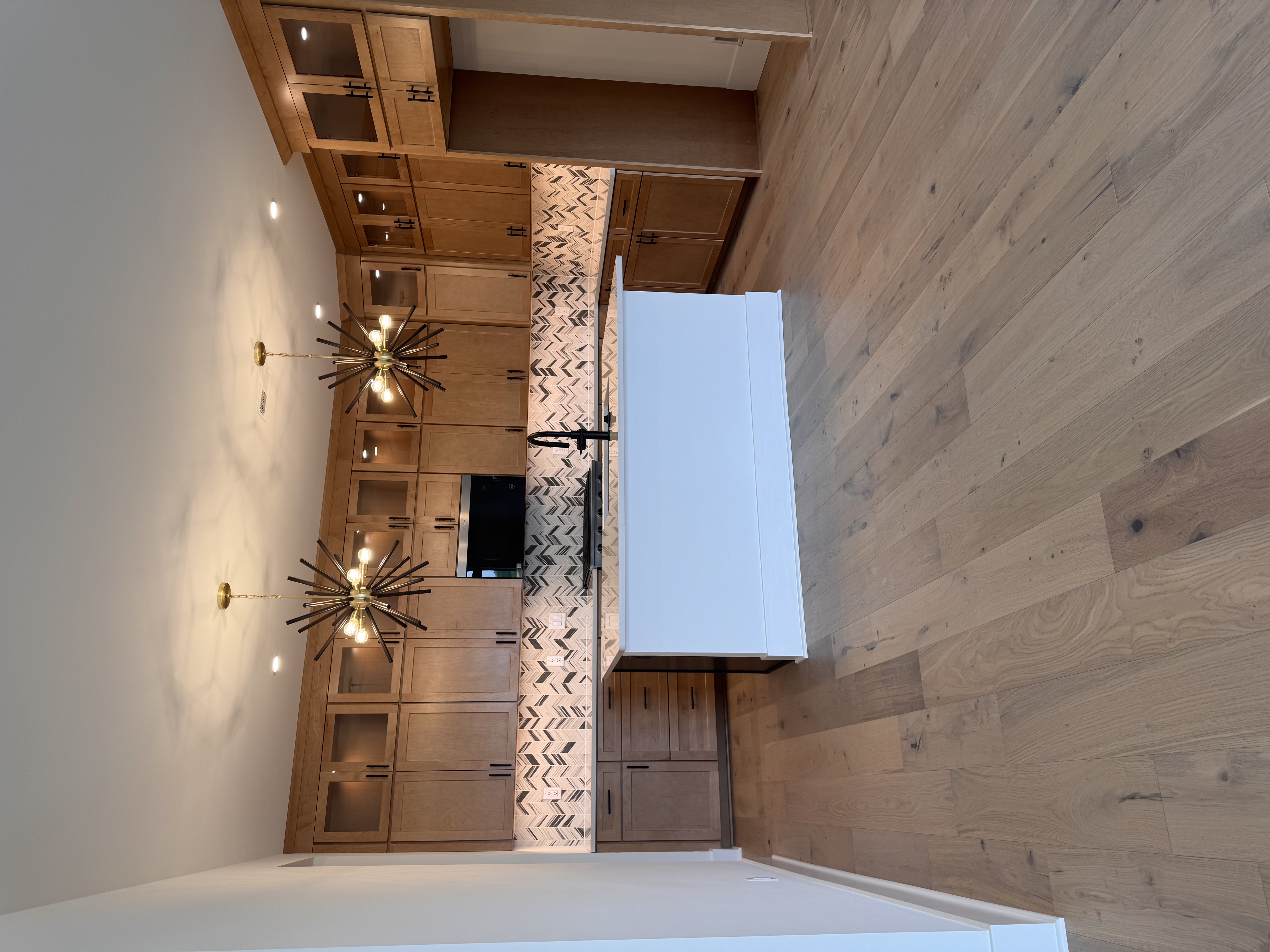 Warm wood kitchen finishes in a Southeast Michigan new construction model home design center