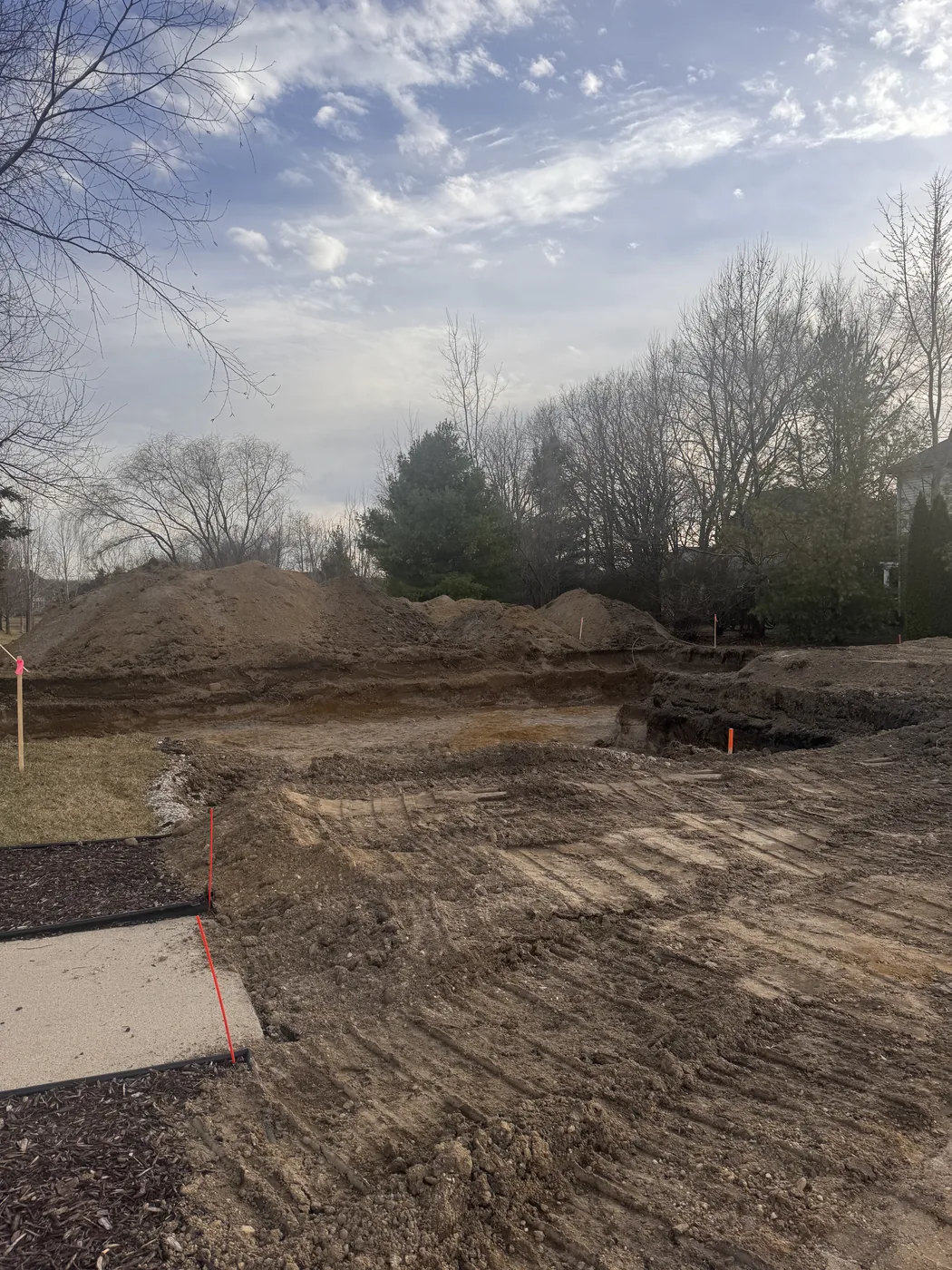 Homesite selection sign marking a cleared new construction lot before building begins in Southeast Michigan